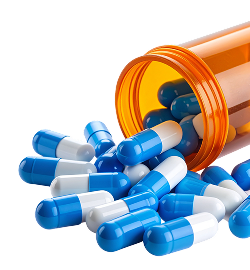 Blue and white supplement capsules spilling from bottle